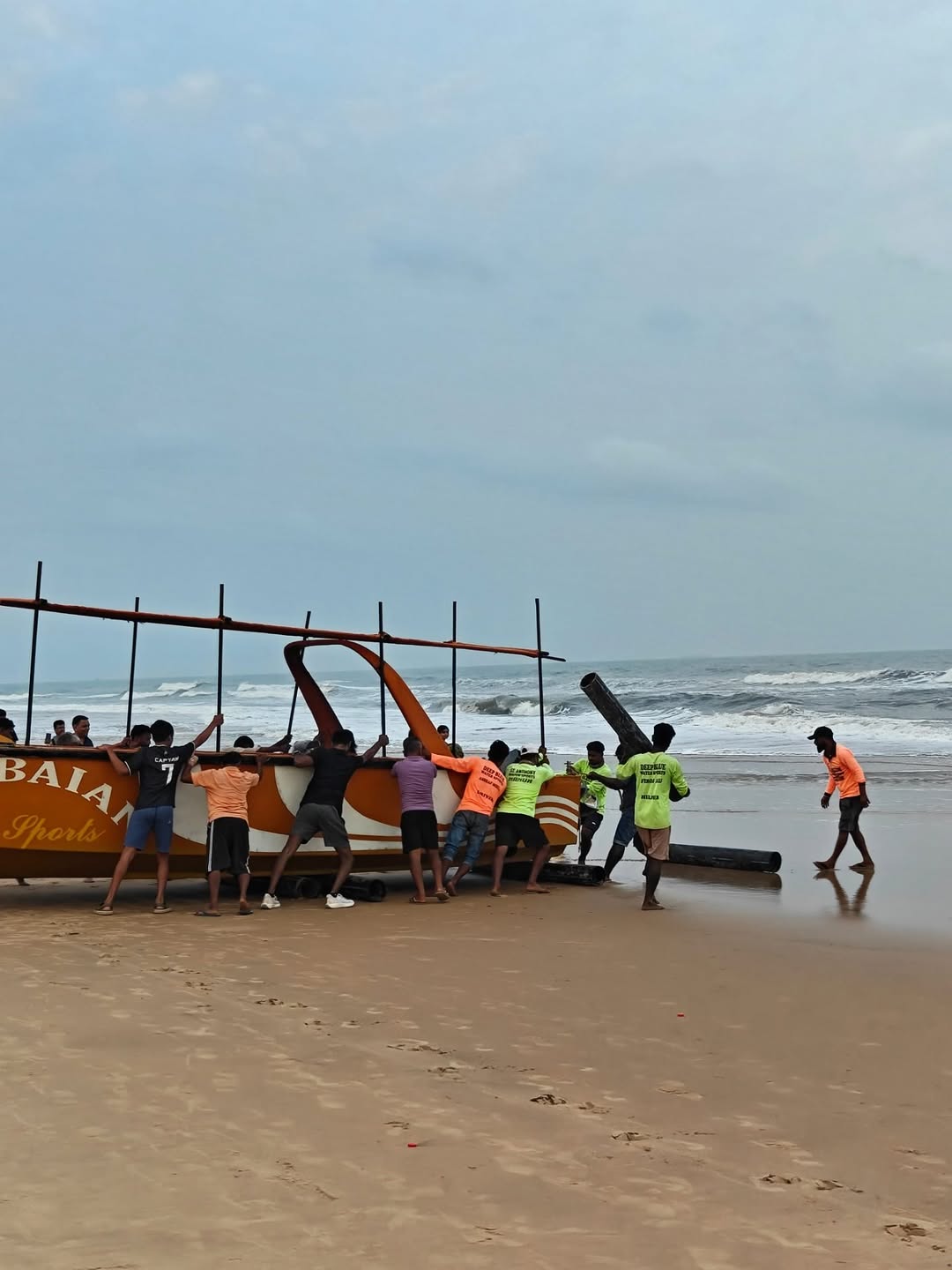Rolling the boat over logs toward the surf